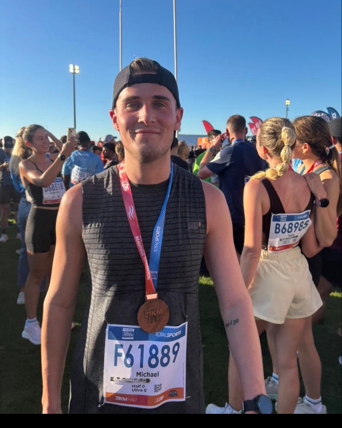 Michael after finishing a half marathon, medal around his neck